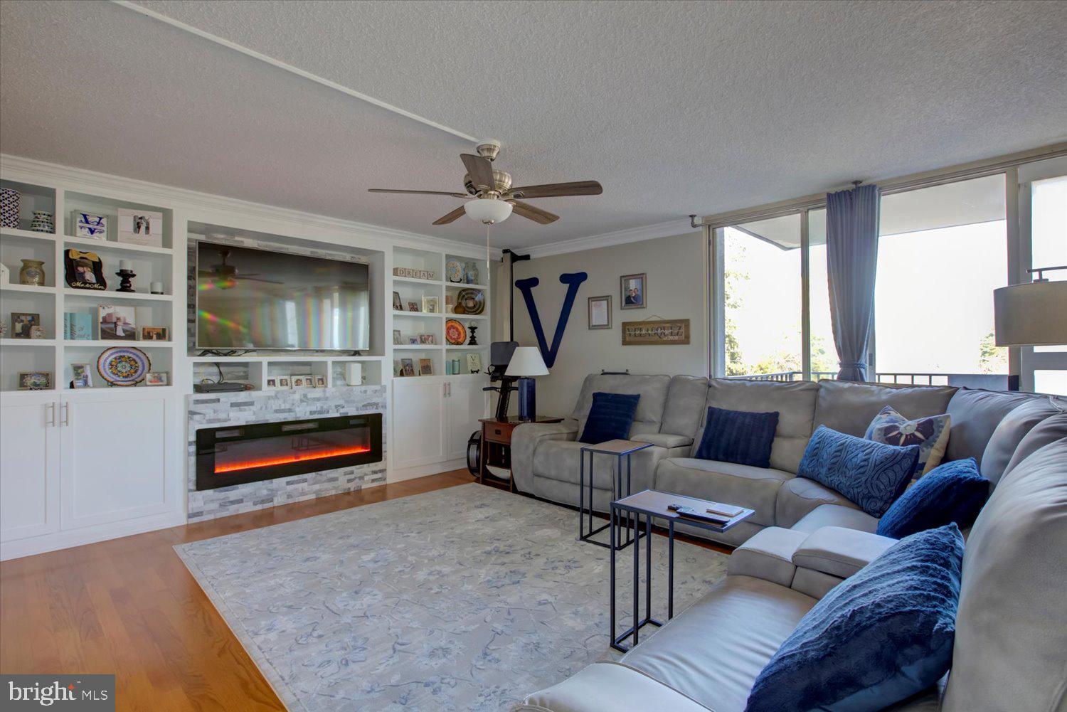 1515 South Arlington Ridge Road, Unit 305 Arlington, VA 22202 - Photo 4 of 41 a living room with furniture and a fireplace
