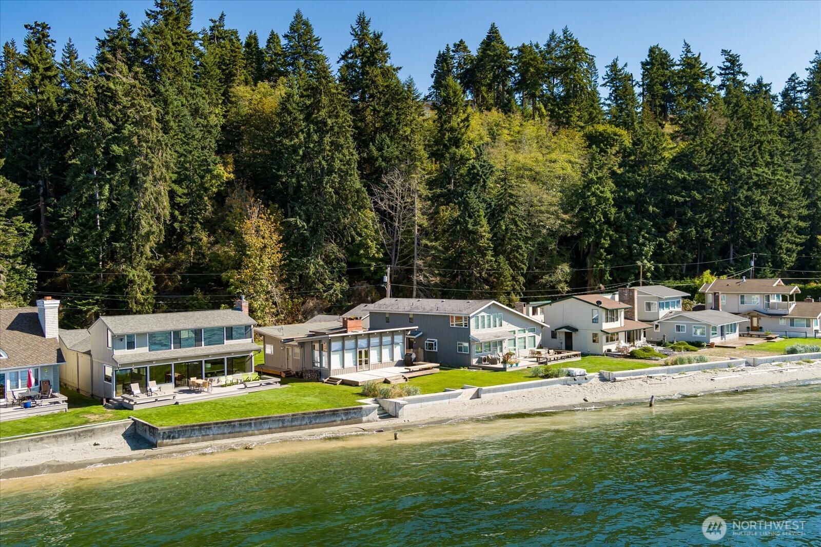 6278 Barr Beach Road Freeland, WA 98249 - Photo 5 of 40 a view of swimming pool with lawn chairs and large trees