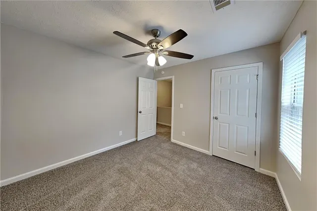 a view of an empty room and a window