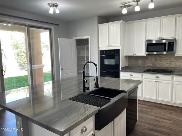a kitchen with a stove a sink and a microwave