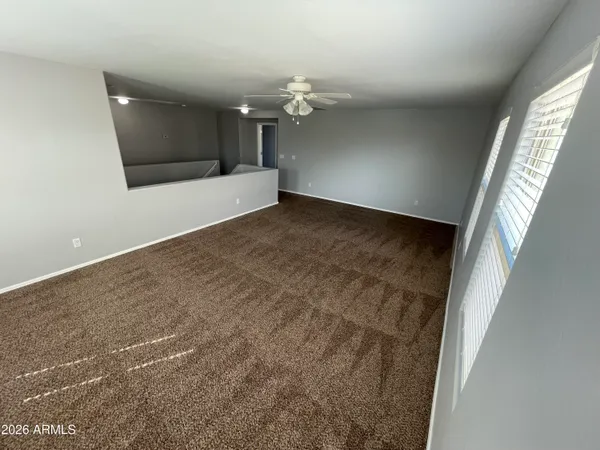 a view of a livingroom with wooden floor and staircase