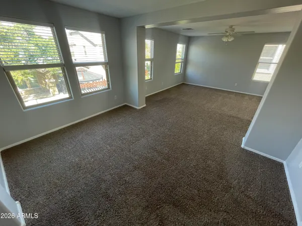 an empty room with windows and closet