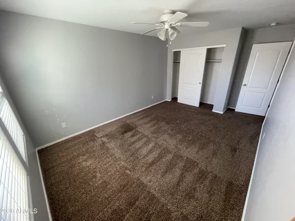a view of a big room with closet and windows