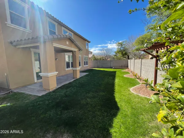 a view of a house with a yard and fence