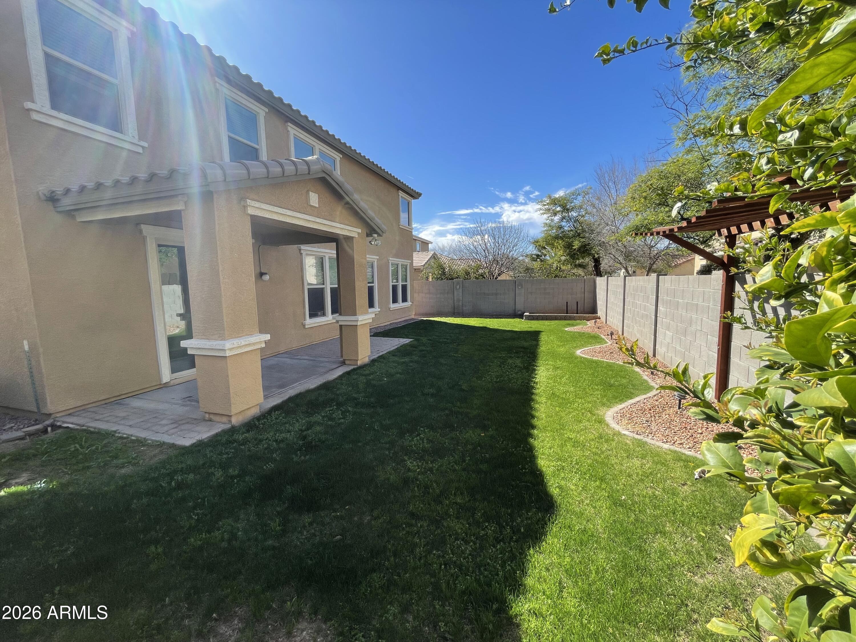 3448 East Merrill Avenue Gilbert, AZ 85234 - Photo 26 of 26 a view of a house with a yard and fence