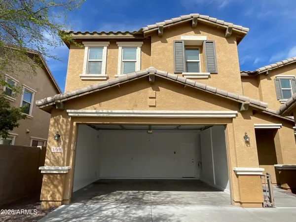 a front view of a house with parking garage