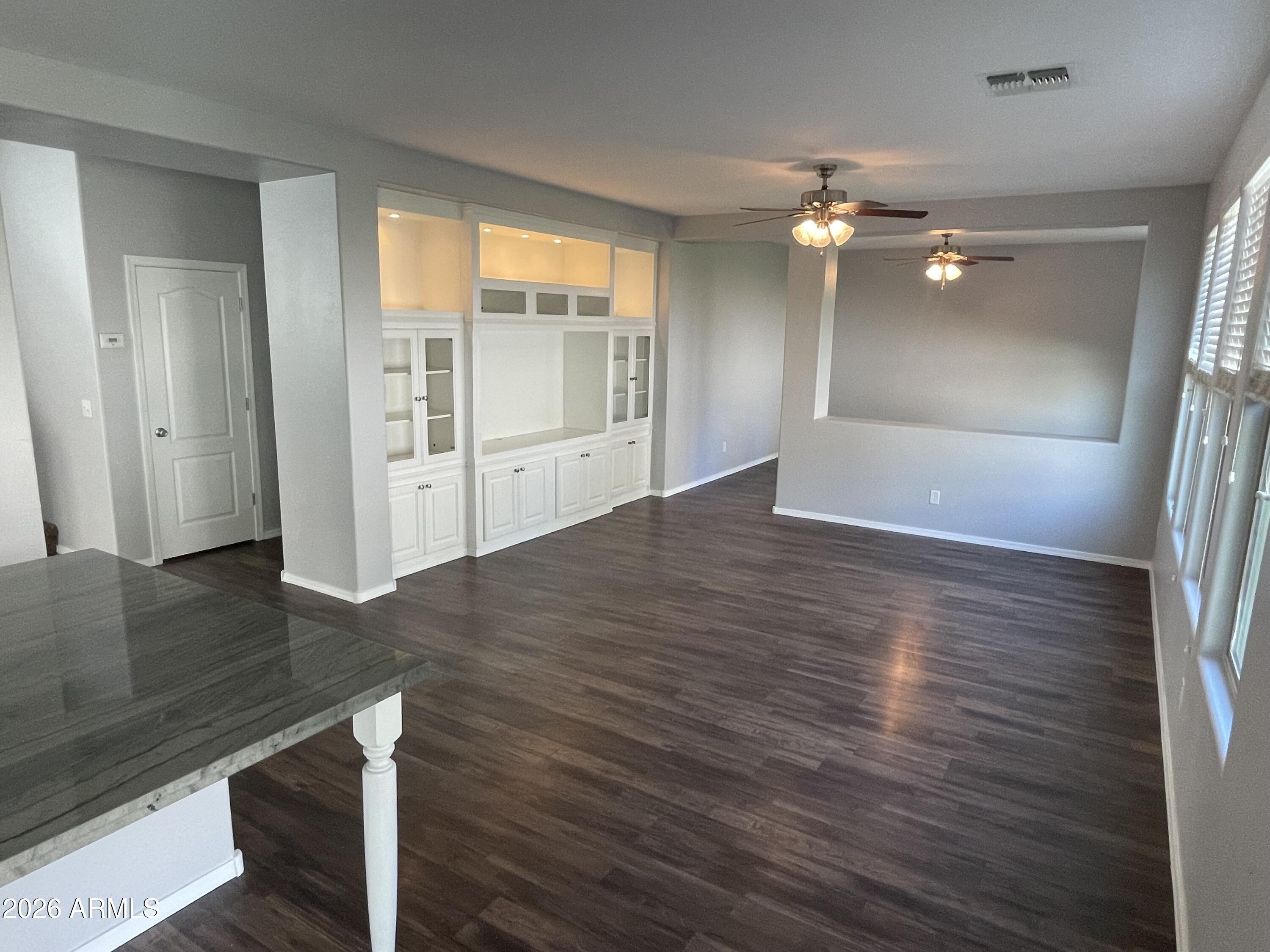 3448 East Merrill Avenue Gilbert, AZ 85234 - Photo 9 of 26 wooden floor in an empty room with a window