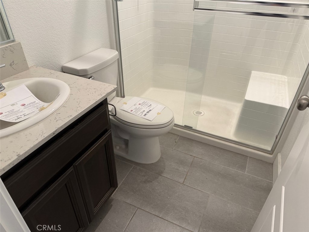 2415 Explorador Drive Merced, CA 95340 - Photo 16 of 28 a bathroom with a granite countertop sink toilet and shower