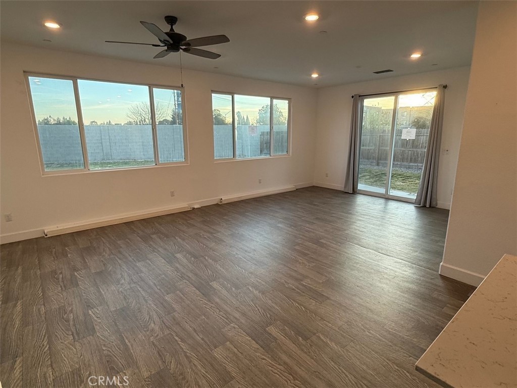 2415 Explorador Drive Merced, CA 95340 - Photo 20 of 28 an empty room with wooden floor fan and windows