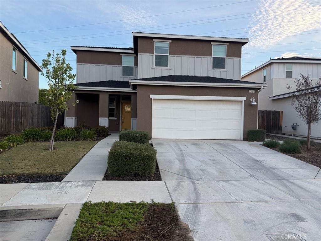 2415 Explorador Drive Merced, CA 95340 - Photo 2 of 28 a front view of a house with a yard and garage