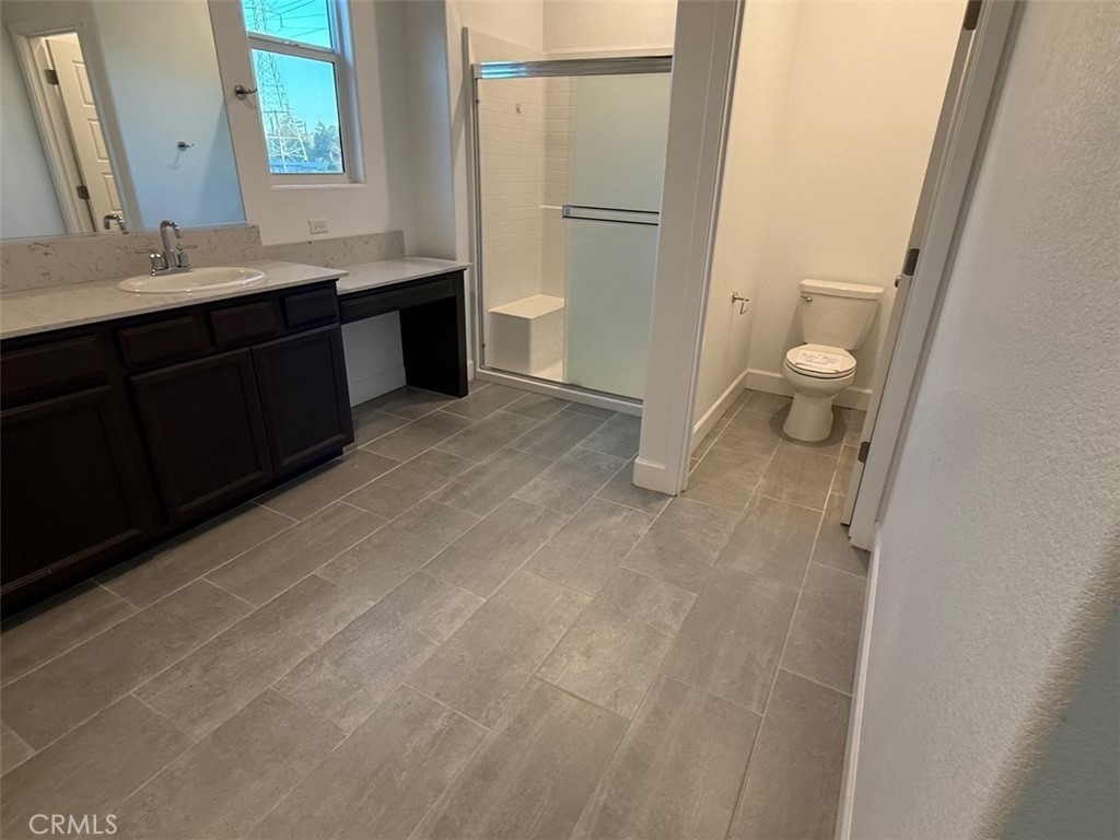 2415 Explorador Drive Merced, CA 95340 - Photo 22 of 28 a spacious bathroom with a double vanity sink toilet and a tub