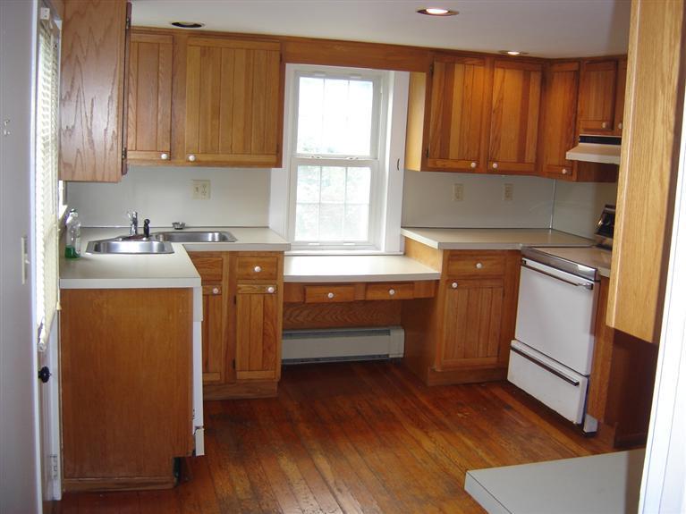 262 Fuller Road Centerville, MA 02632 - Photo 9 of 17 a kitchen with a sink a stove cabinets and wooden floor