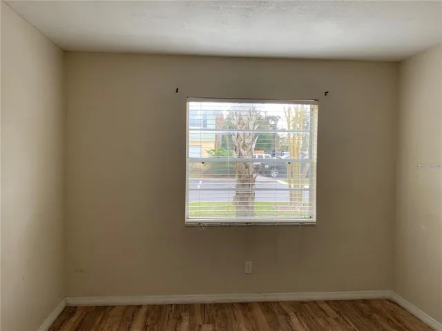 a view of a hallway with closet and a door