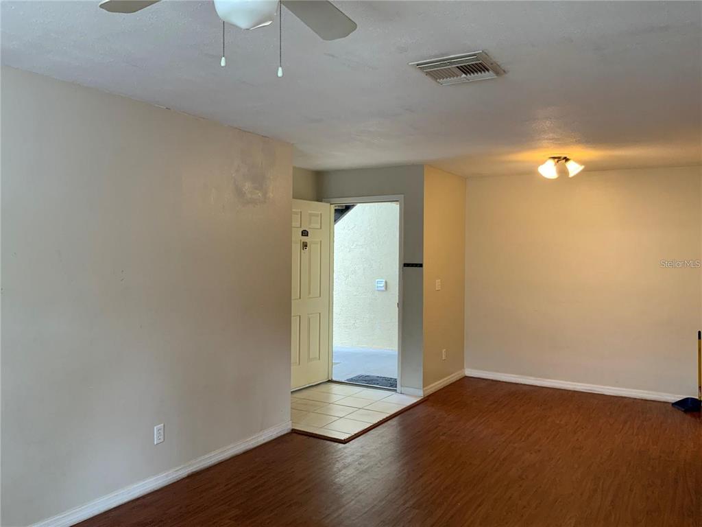 233 Red Maple Place, Unit 233 Brandon, FL 33510 - Photo 14 of 16 an empty room with wooden floor and windows