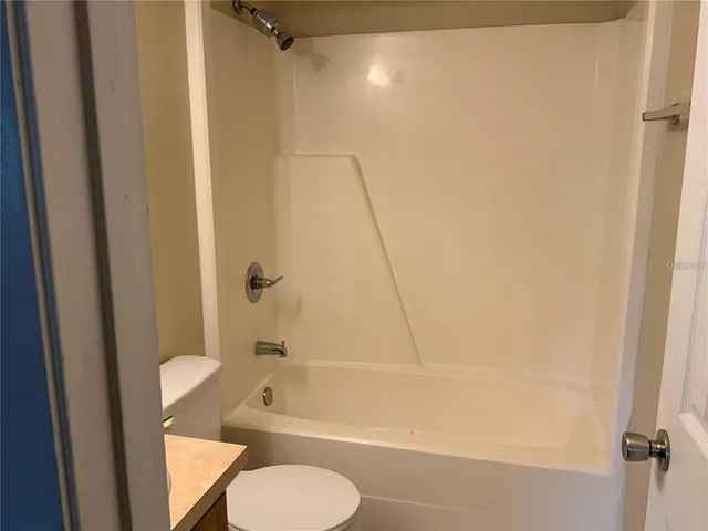 a bathroom with a toilet and a tub