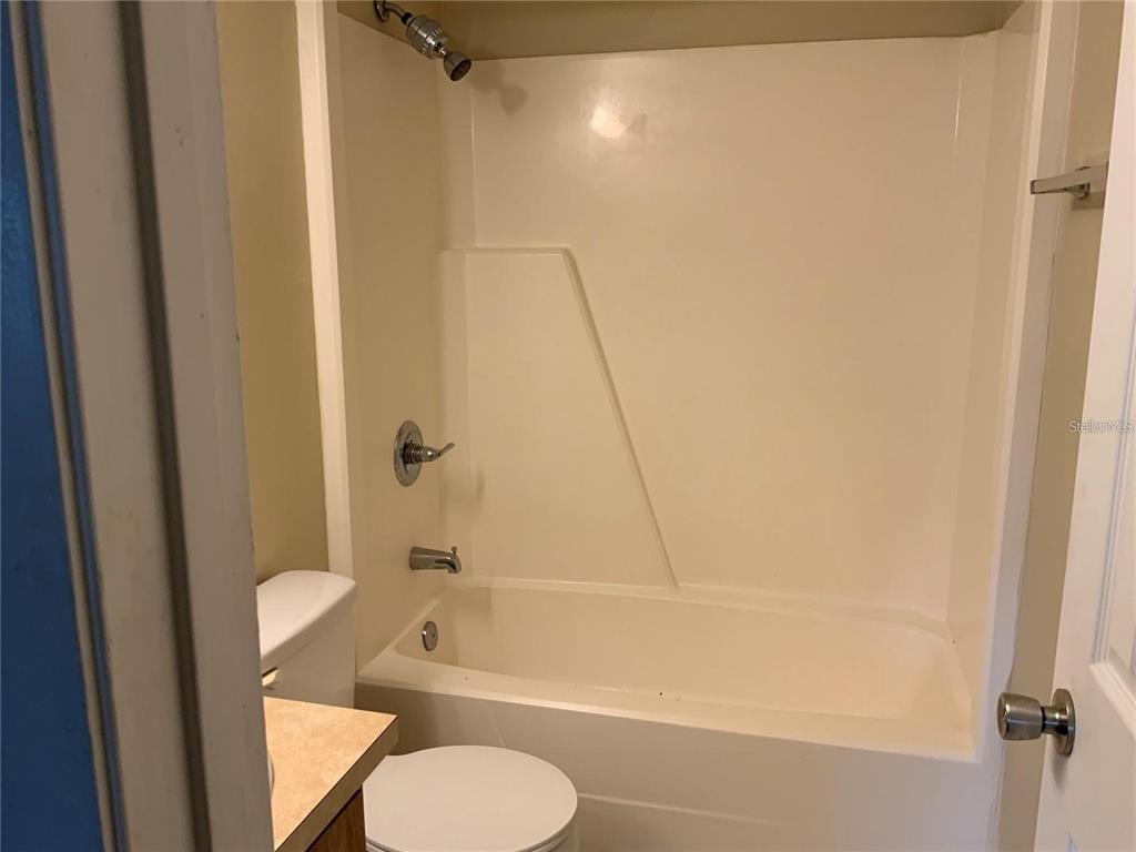 233 Red Maple Place, Unit 233 Brandon, FL 33510 - Photo 4 of 16 a bathroom with a toilet and a tub