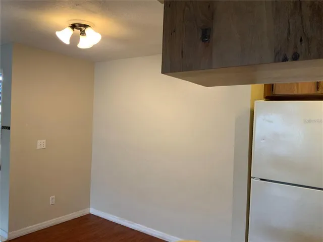 a kitchen with a refrigerator and a stove