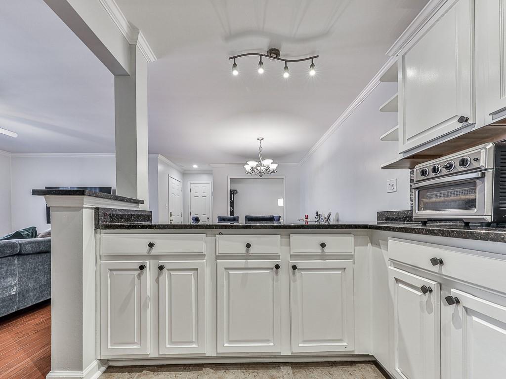1708 Brighton Point Atlanta, GA 30328 - Photo 12 of 31 a kitchen with white cabinets and sink