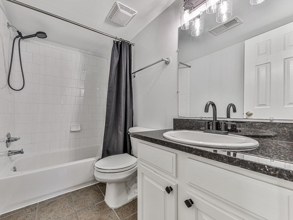 1708 Brighton Point Atlanta, GA 30328 - Photo 16 of 31 a bathroom with a granite countertop sink a toilet and a mirror