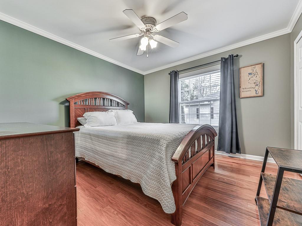 1708 Brighton Point Atlanta, GA 30328 - Photo 17 of 31 a bedroom with a bed and a chandelier