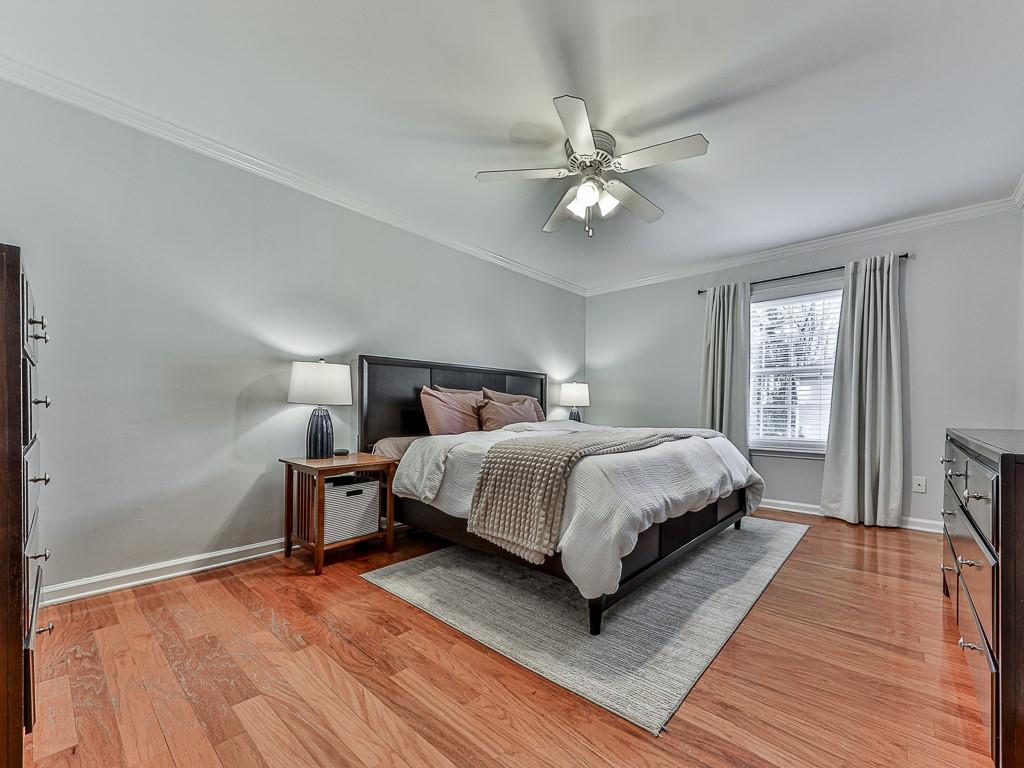 1708 Brighton Point Atlanta, GA 30328 - Photo 18 of 31 a bedroom with a bed and wooden floor
