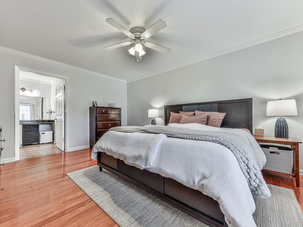 1708 Brighton Point Atlanta, GA 30328 - Photo 19 of 31 a bedroom with a large bed and a chandelier