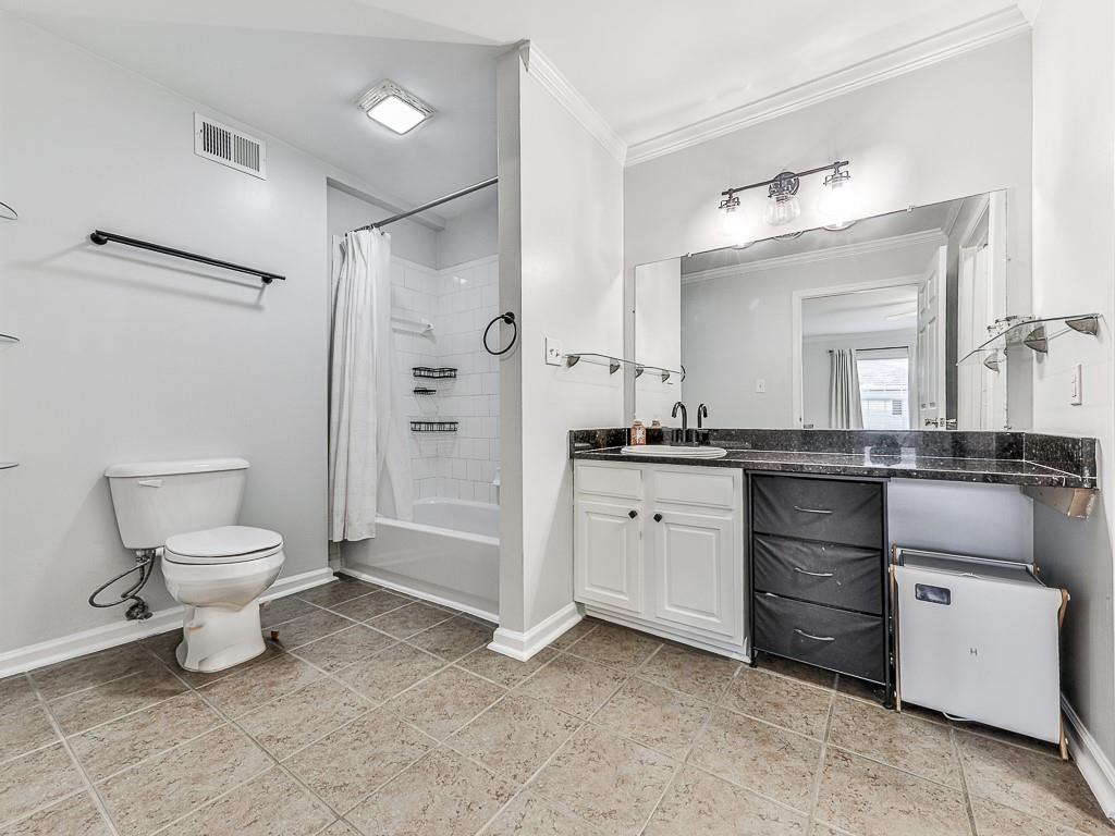 1708 Brighton Point Atlanta, GA 30328 - Photo 20 of 31 a bathroom with a toilet a sink and a mirror
