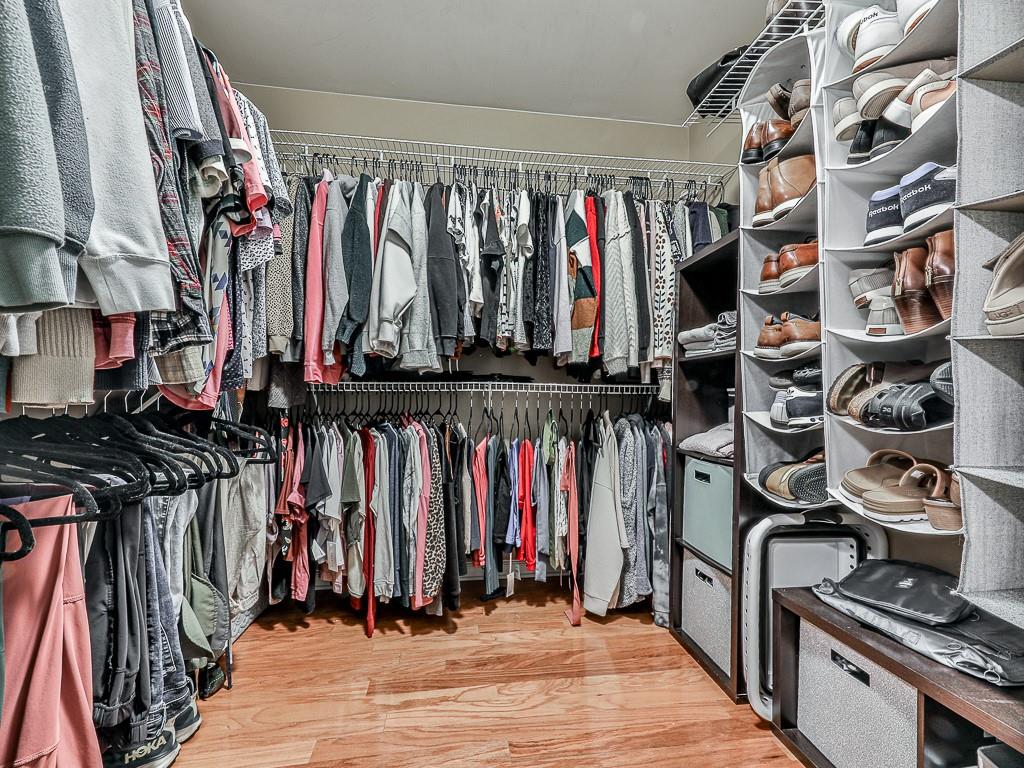 1708 Brighton Point Atlanta, GA 30328 - Photo 21 of 31 a view of walk in closet with clothes and shoes