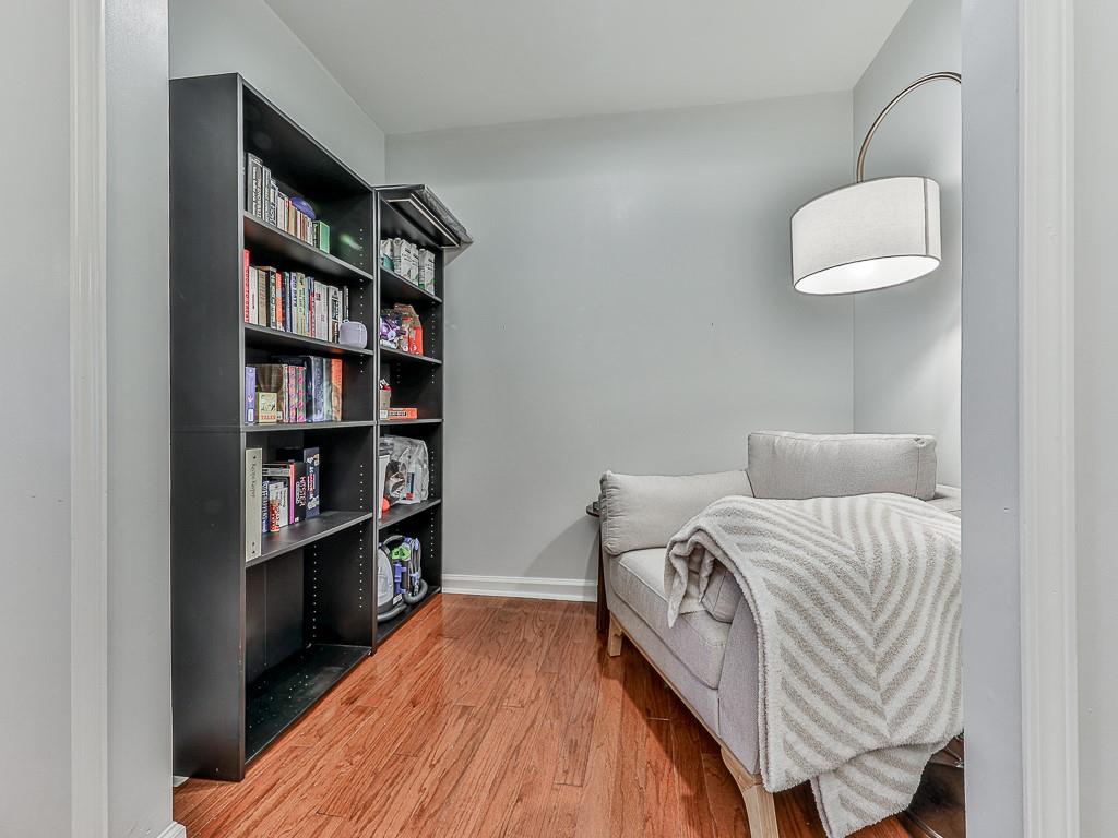 1708 Brighton Point Atlanta, GA 30328 - Photo 22 of 31 a bedroom with a bed and a book shelf