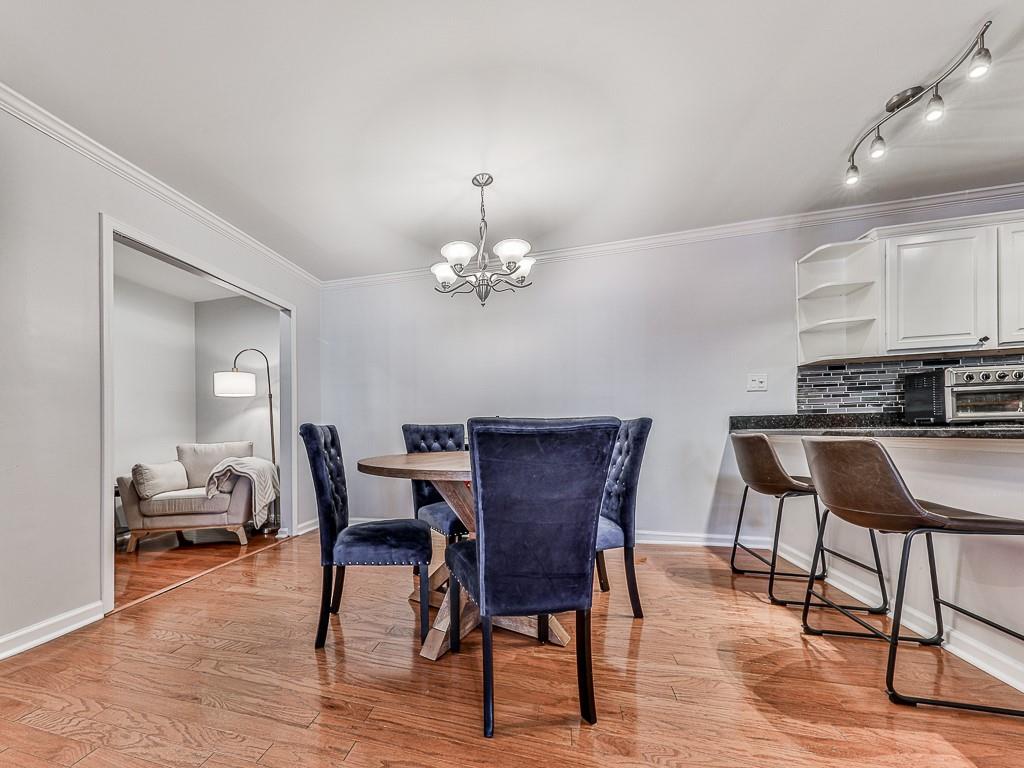 1708 Brighton Point Atlanta, GA 30328 - Photo 5 of 31 a view of a dining room with furniture and wooden floor