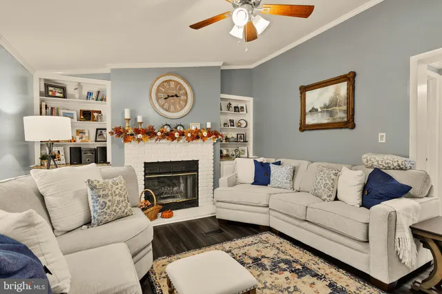 a living room with furniture a clock and a fireplace