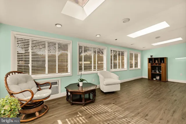 a living room with furniture and large windows