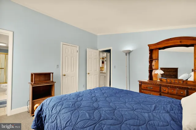 a bedroom with a bed and dresser