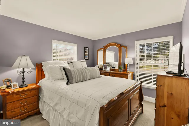 a bed room with a bed and a large window