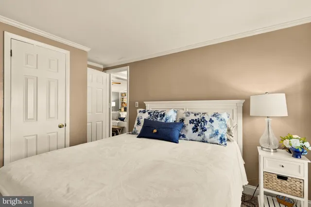 a bedroom with a bed and a lamp