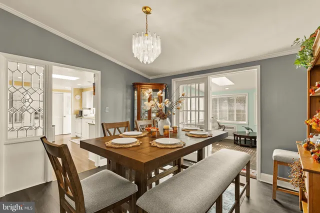 a view of a dining room with furniture wooden floor and a chandelier
