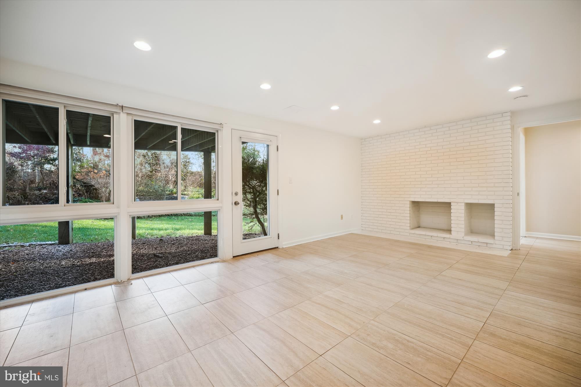 8328 Fenway Road Bethesda, MD 20817 - Photo 33 of 62 Recreation Room w/ Fireplace and Backyard Access