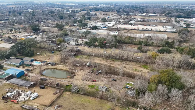 an aerial view of residential house and covered with trees