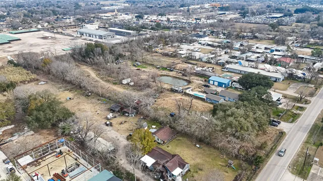 an aerial view of residential house with yard and mountain view in back