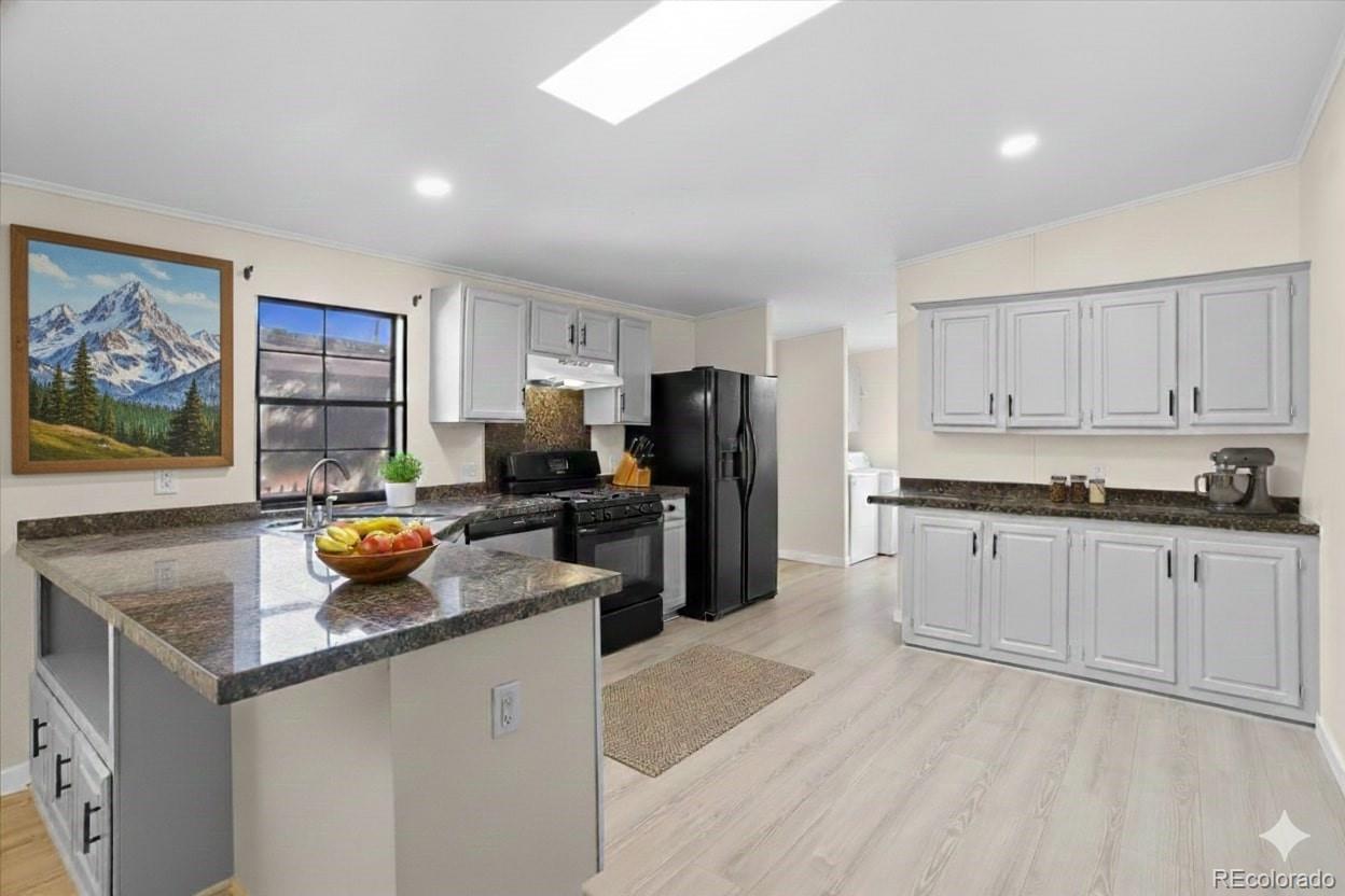 218 Grape Street Hudson, CO 80642 - Photo 12 of 22 a kitchen with a refrigerator and microwave