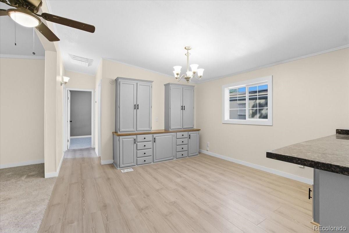 218 Grape Street Hudson, CO 80642 - Photo 15 of 22 a view of an empty room with window and wooden floor