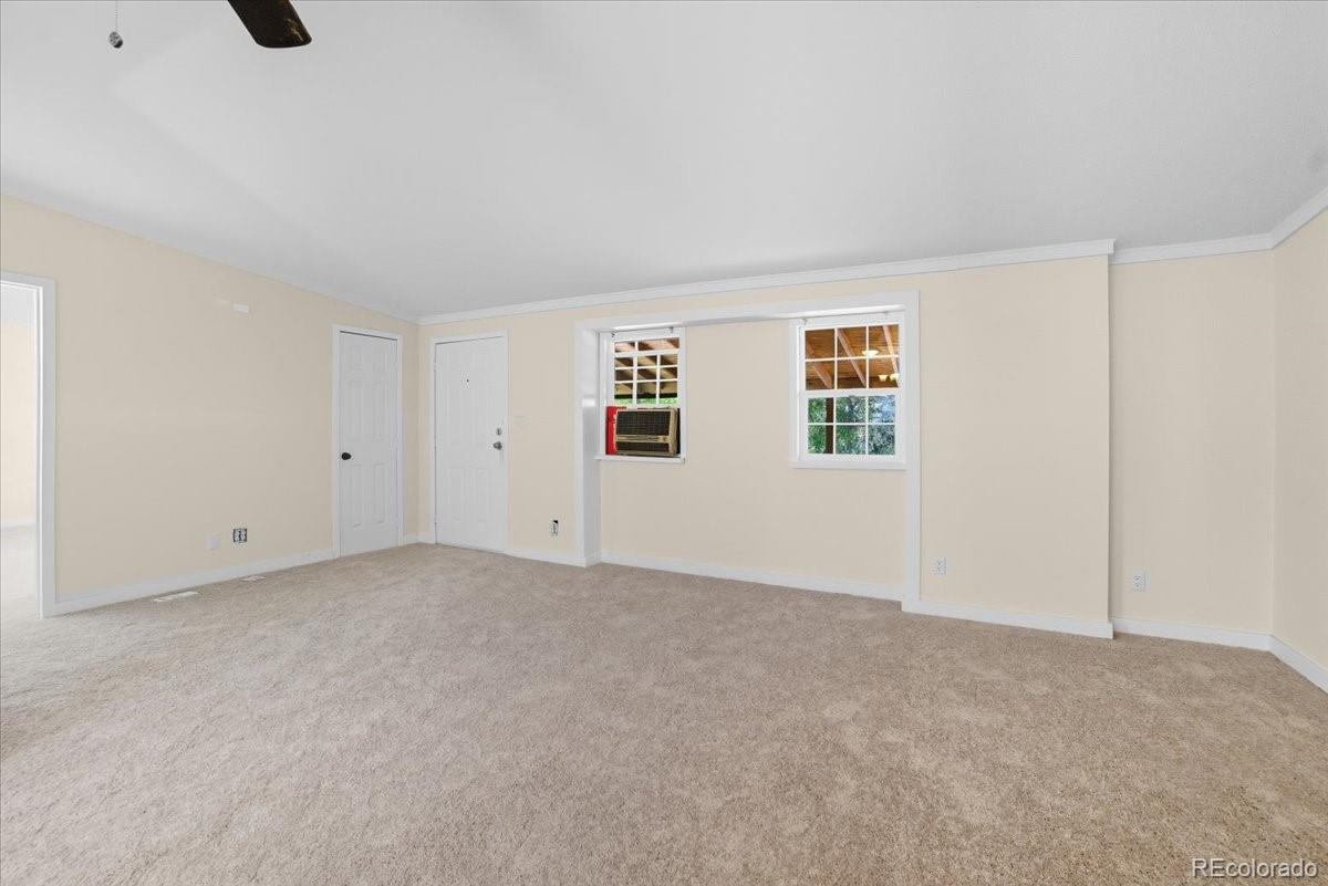 218 Grape Street Hudson, CO 80642 - Photo 5 of 22 a view of an empty room with windows