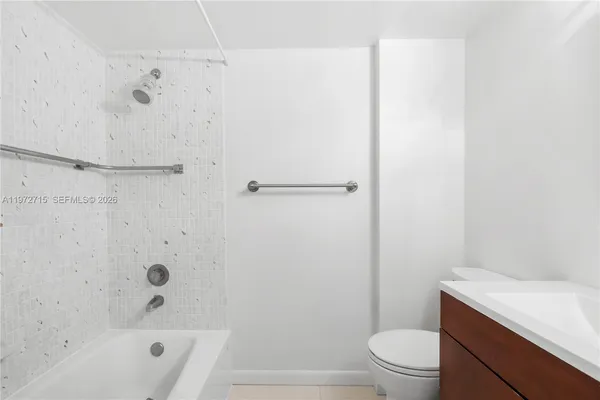 a bathroom with a shower a toilet and a sink