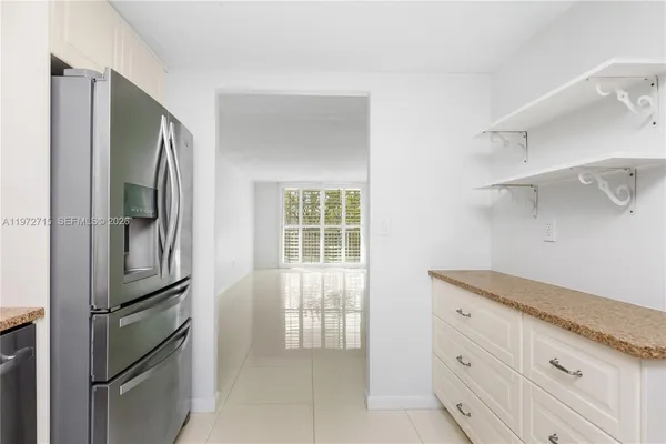 a kitchen with cabinets and stainless steel appliances