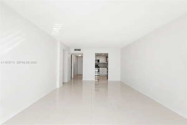 a view of an empty room with closet