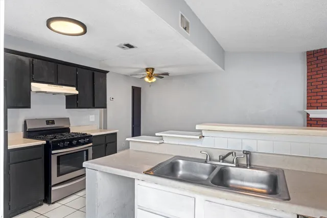 a kitchen that has a sink and a stove