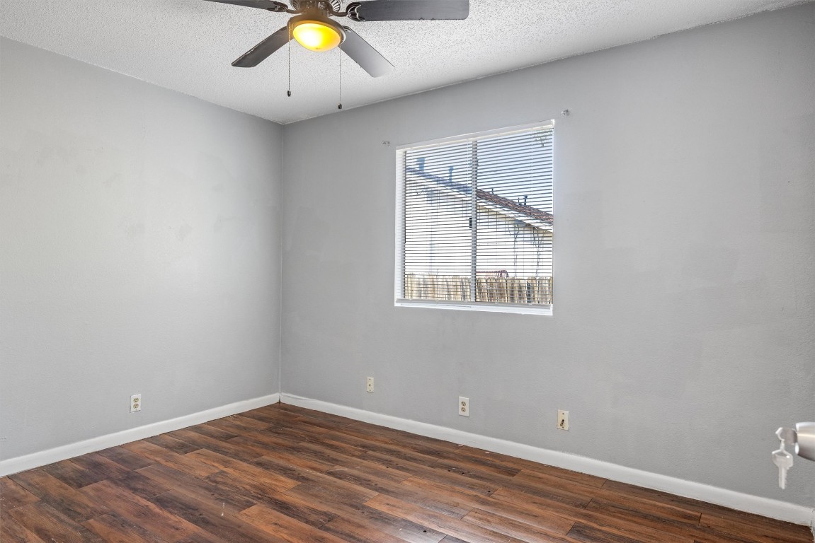 1704 Rawhide Loop Round Rock, TX 78681 - Photo 7 of 11 an empty room with wooden floor and windows