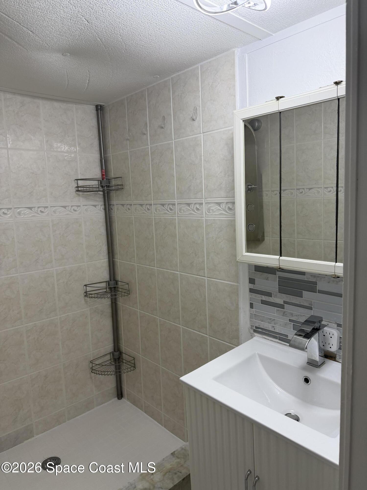 2132 Rocway Drive Melbourne, FL 32935 - Photo 14 of 16 a bathroom with a sink a toilet and shower