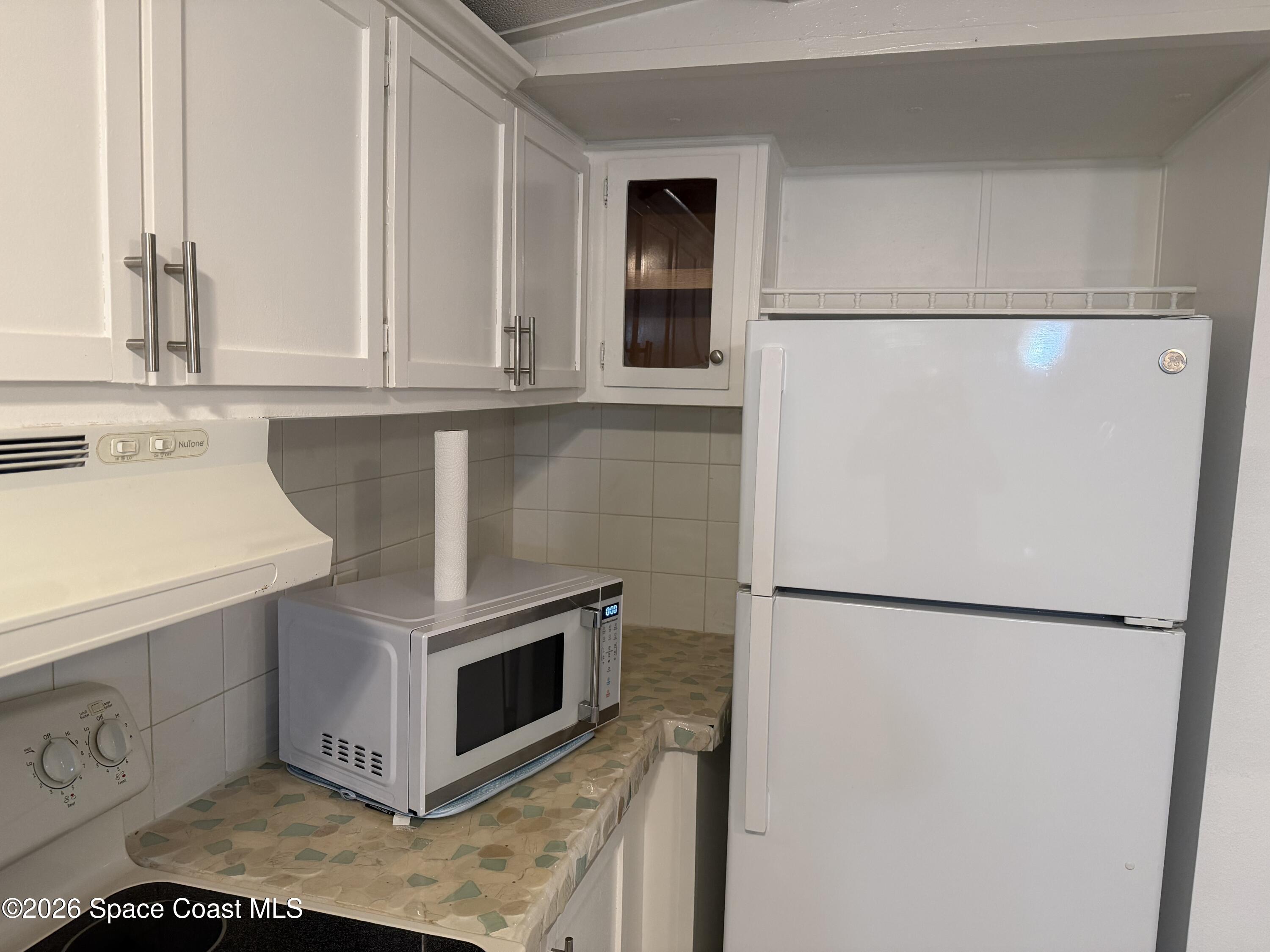 2132 Rocway Drive Melbourne, FL 32935 - Photo 6 of 16 a kitchen with stainless steel appliances white cabinets and a refrigerator