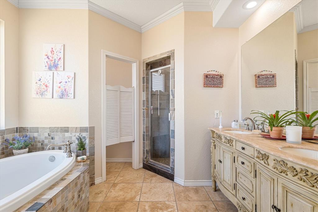 2885 Enloe Road Howe, TX 75459 - Photo 24 of 39 a bathroom with a tub sink and mirror